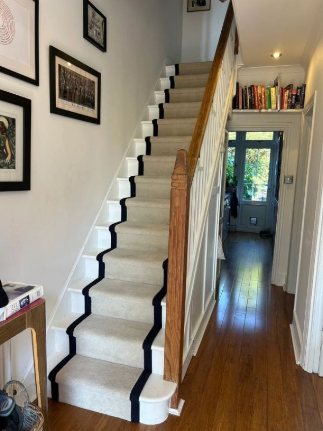 cream stair runner carpet with black tape edging in hallway